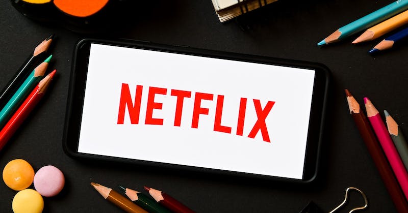 In this photo illustration a Netflix logo seen displayed on
