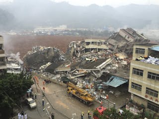 深圳 Damaged buildings are seen as rescuers search for survivors after a landslide hit an industrial park in Shenzhen