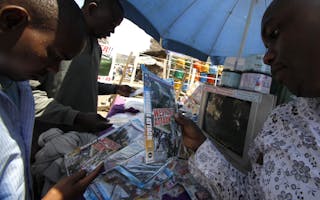 Residents browse for DVDs titled "Westgate Attack" displayed for sale at an outdoor market in a slum at Mathare in Nairobi