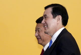Chinese President Xi Jinping and Taiwan's President Ma Ying-jeou leave after shaking hands during a summit in Singapore