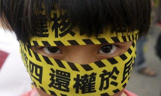 A Taiwanese boy wears a slogan reading "Stop the 4th Nuclear Power Plant. Give Power Back to People," during a protest against the construction of Taiwan's fourth nuclear power plant to be completed i
