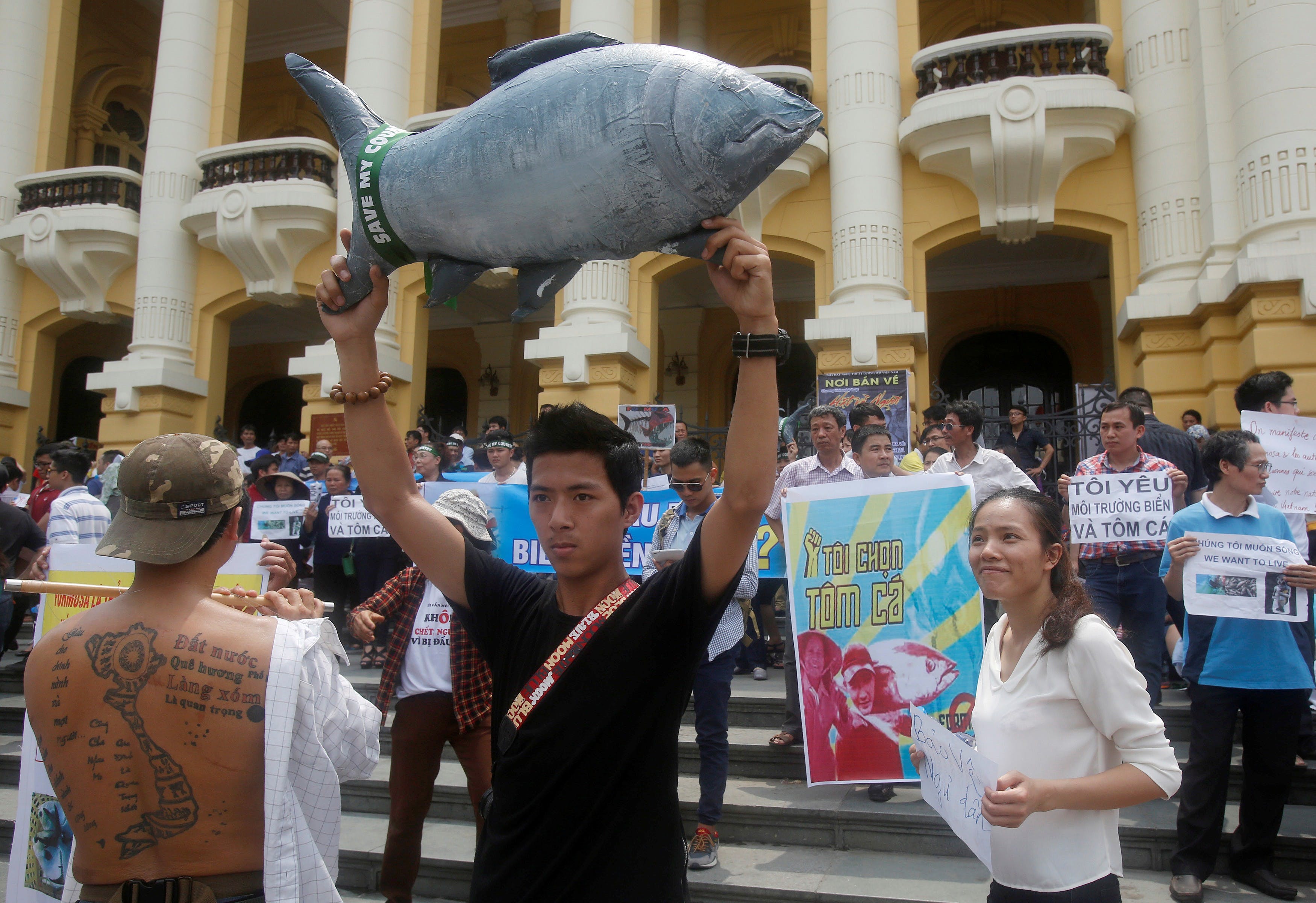 Demonstrators, holding signs of environmental-friendly messages, say they are demanding cleaner waters in the central regions after mass fish deaths in recent weeks, in Hanoi, Vietnam