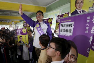 Alvin Yeung, a candidate from Civic Party, waves at a campaign rally during a legislative by-election in Hong Kong