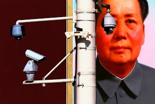 Security cameras are attached to pole in front of portrait of former Chinese Chairman Mao on Beijing's Tiananmen Square
