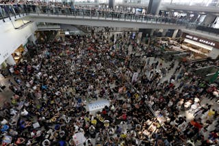 Hundreds of airlines related staff and citizens protest against Hong Kong Chief Executive Leung Chun-ying at the arrival hall of the Hong Kong Airport in Hong Kong