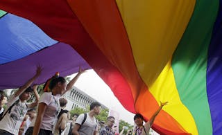 Participants hold giant rainbow flags during the Taiwan LGBT Pride Parade in Taipei