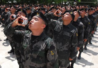 Members of Regional Mobile Group drink beer during the ceremonial toast for their graduation at a police training camp in Sibonga