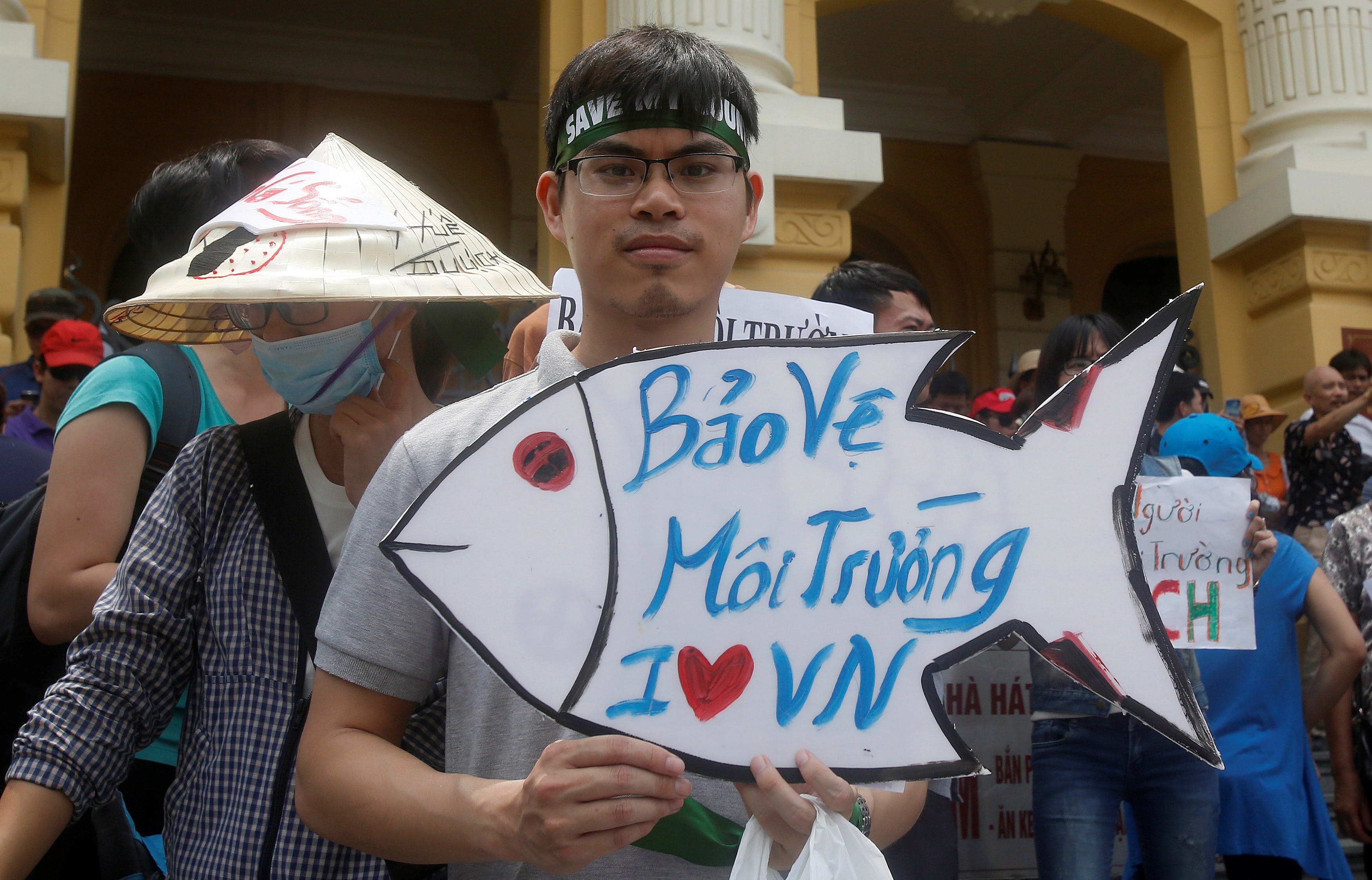 A demonstrator holds a sign during a protest where they say they are demanding cleaner waters in the central regions after mass fish deaths in recent weeks, in Hanoi, Vietnam