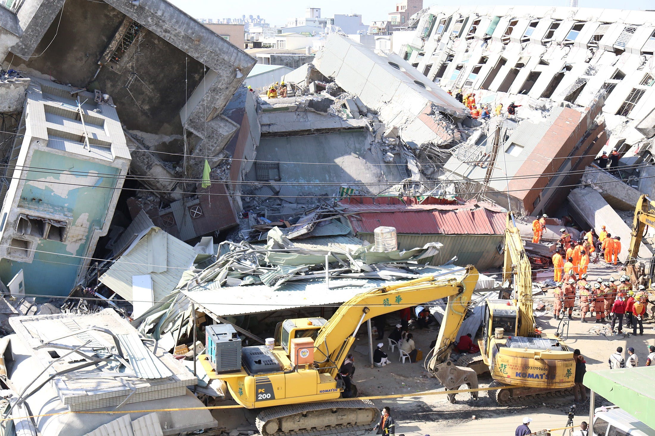 Rescue crews search through the rubble of the toppled Wei-guan Golden Dragon complex in Yongkang District of Tainan City. Photo Credit: Tony Coolidge