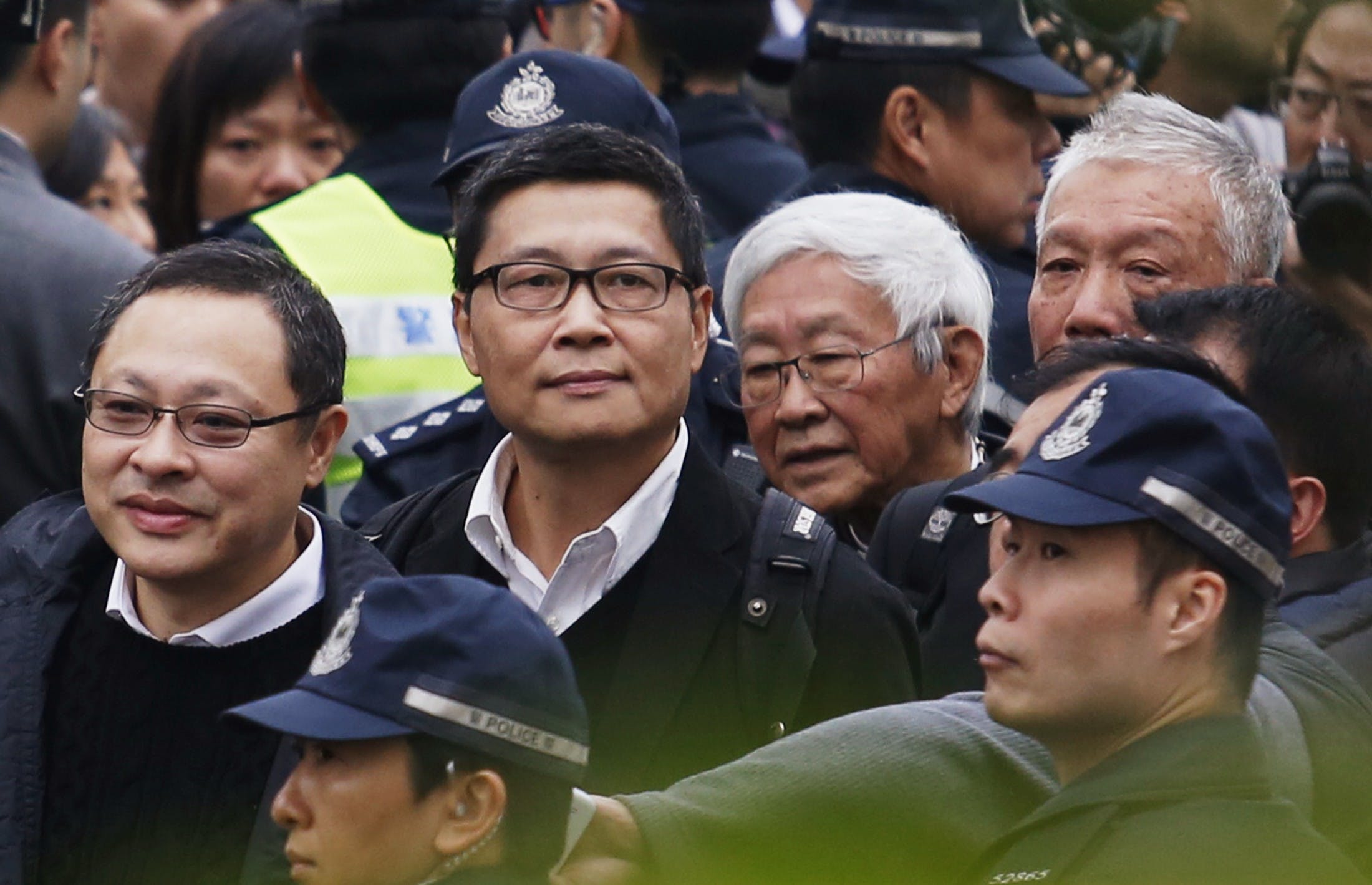 Professor Tai, professor Chan, Cardinal Zen and Reverend Chu walk to Central Police Station before voluntarily surrendering themselves to the police in Hong Kong