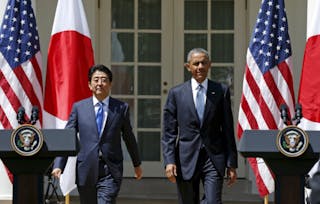 U.S. President Barack Obama and Japanese Prime Minister Shinzo Abe arrive for a joint news conference in the Rose Garden of the White House in Washington