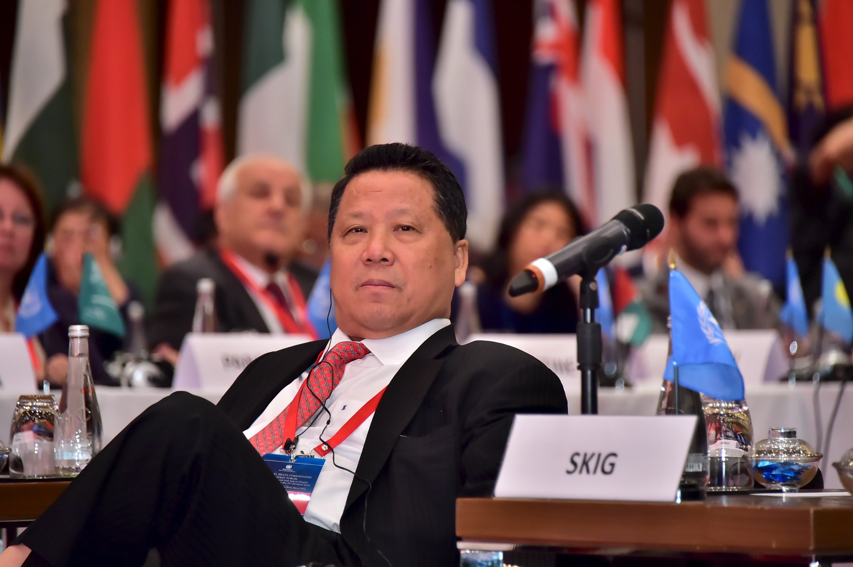 David Ng, Chairman of the Sun Kian IP Group Foundation sits at the High-level Multi-Stakeholder Strategy Forum in Macau