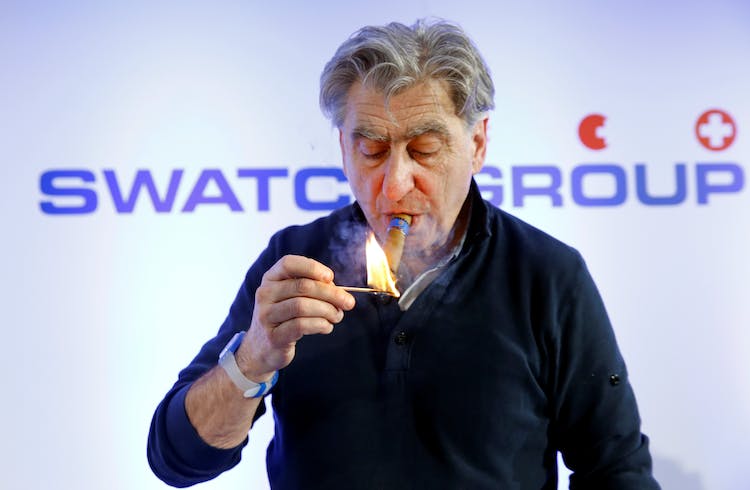 CEO and Chairman of the Board of the Swatch Group Hayek lights a cigar after the news conference in Biel