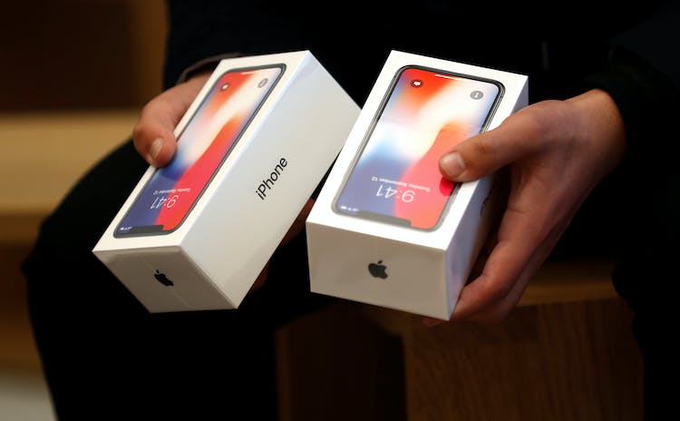 A man holds two boxes for the Apples new iPhone X which went on sale today, at the Apple Store in Regents Street in London