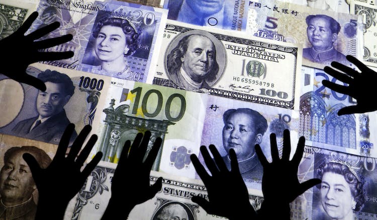 Picture illustration of hands silhouetted against a backdrop projected with the picture of various currencies of money